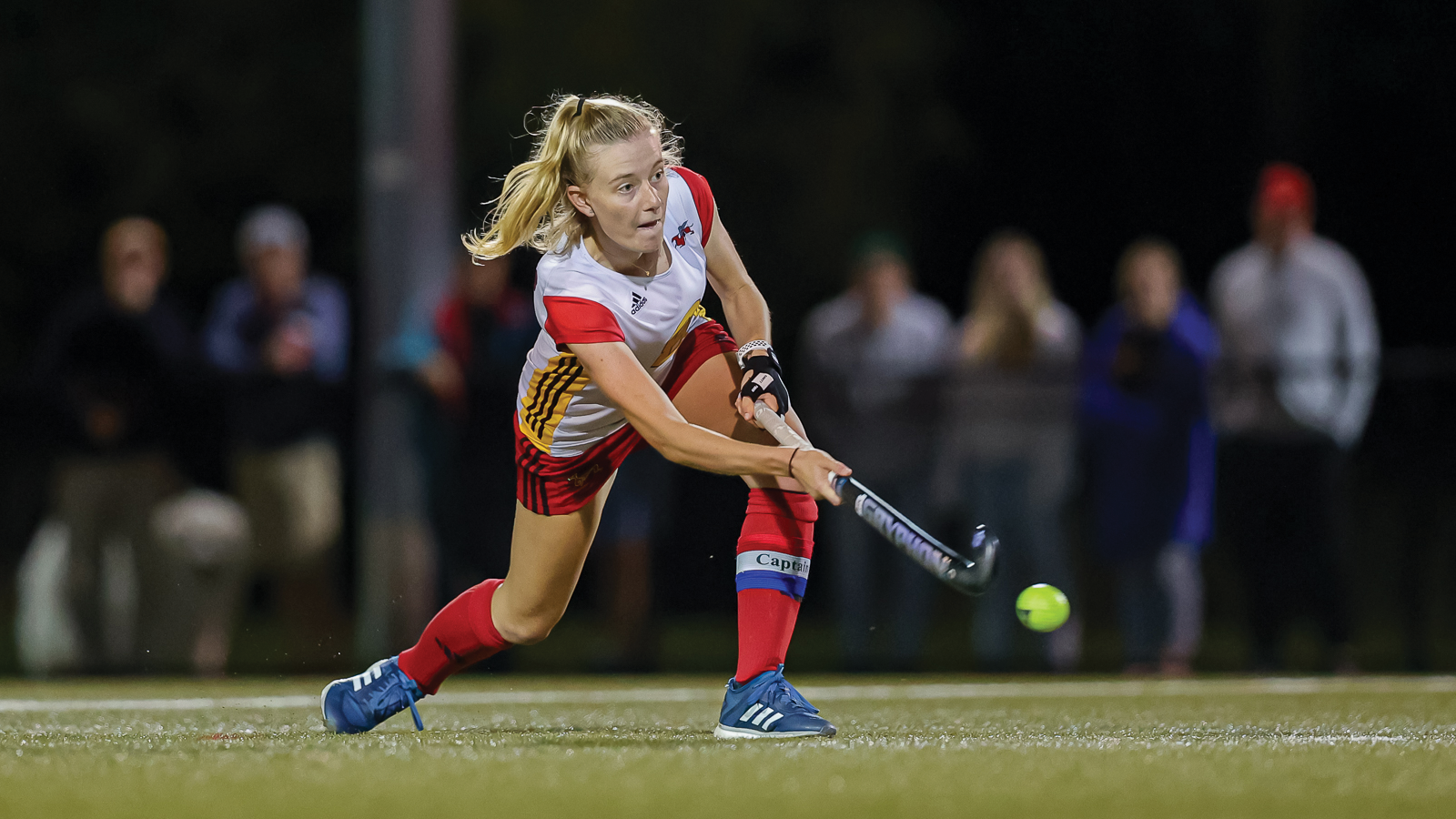 Action photo of Guelph field hockey player Elly Peters shooting the ball during a game