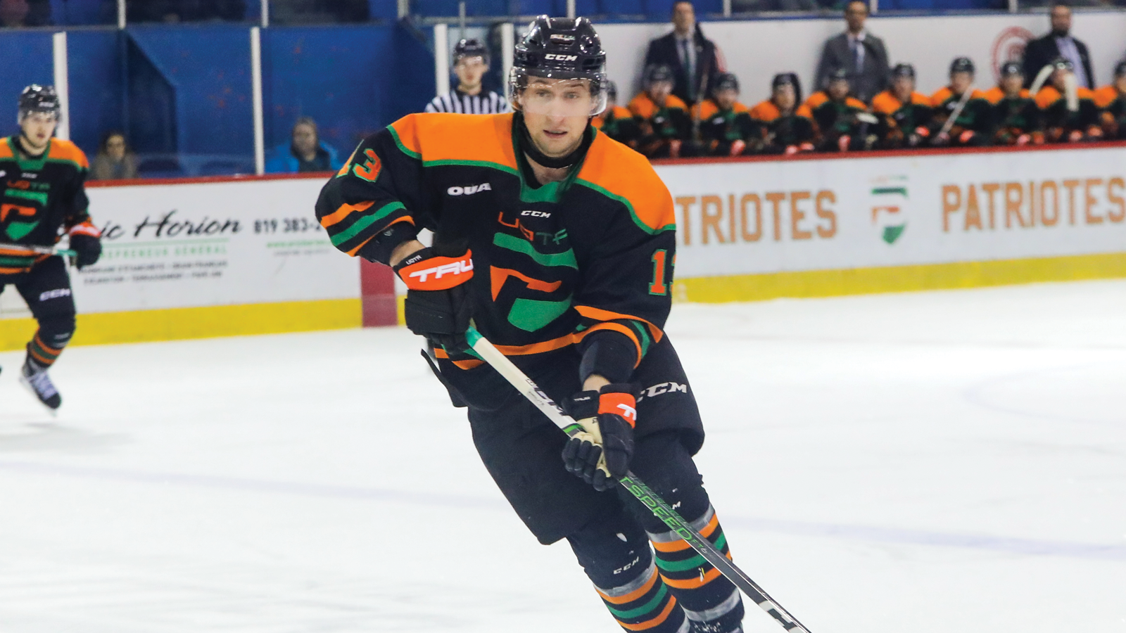 UQTR hockey player Simon Lafrance skating with the puck on his stick during a game