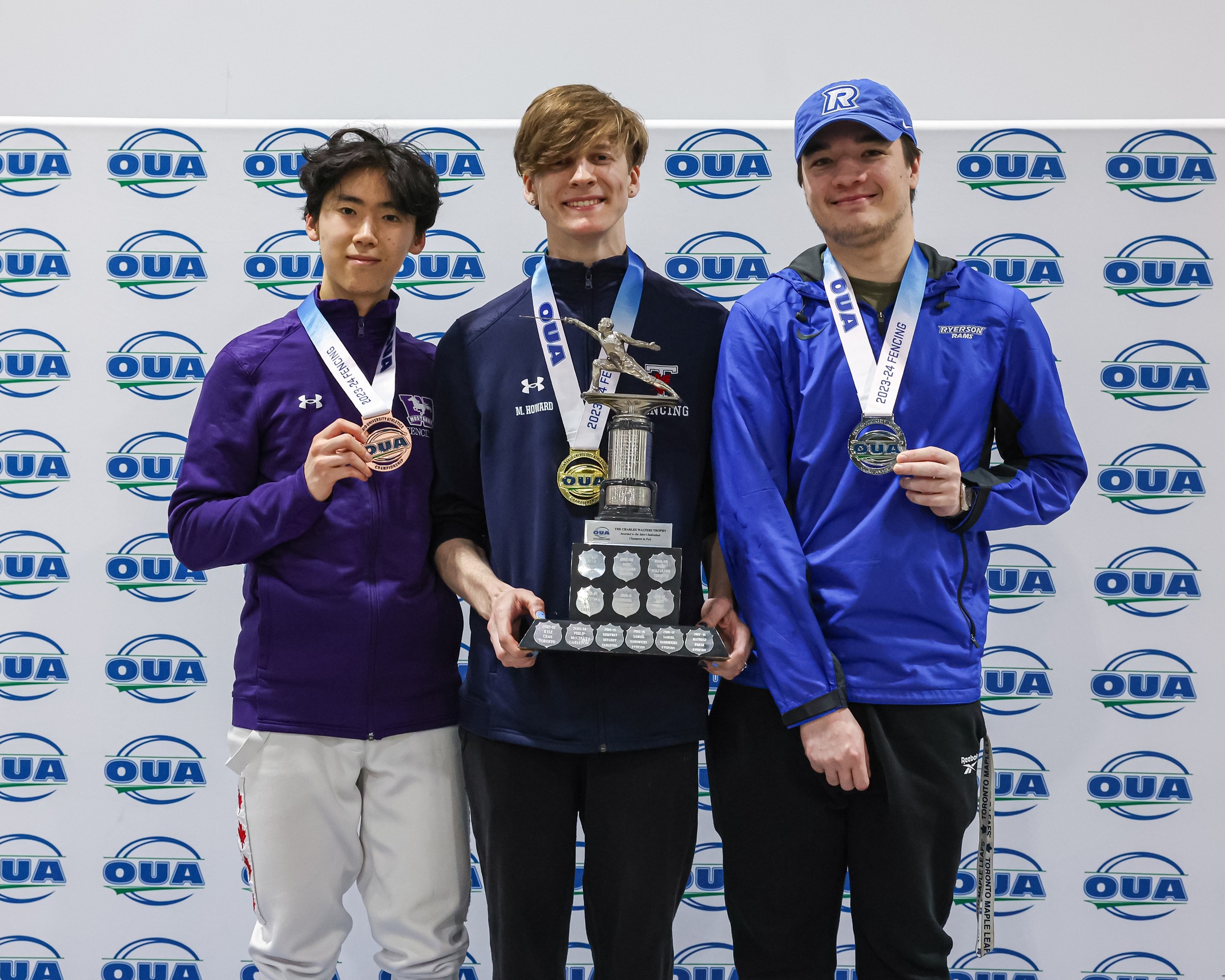 Image of Toronto Varsity Blues Men's Fencer with a gold medal in the middle holding a trophy surrounded by silver and bronze medalists. 