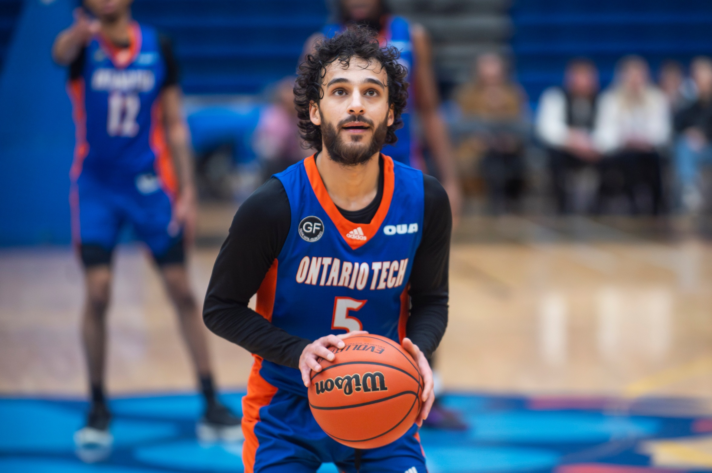 Image of Ontario Tech Ridgebacks Men's Basketball Player Zubair Seyed on the court with a ball in his hands. 