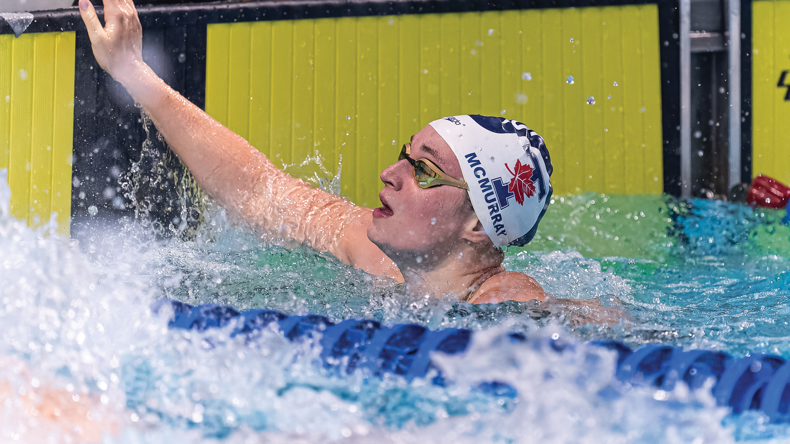 Toronto women's swimmer Ainsley McMurray hanging on to the wall in the pool after a race