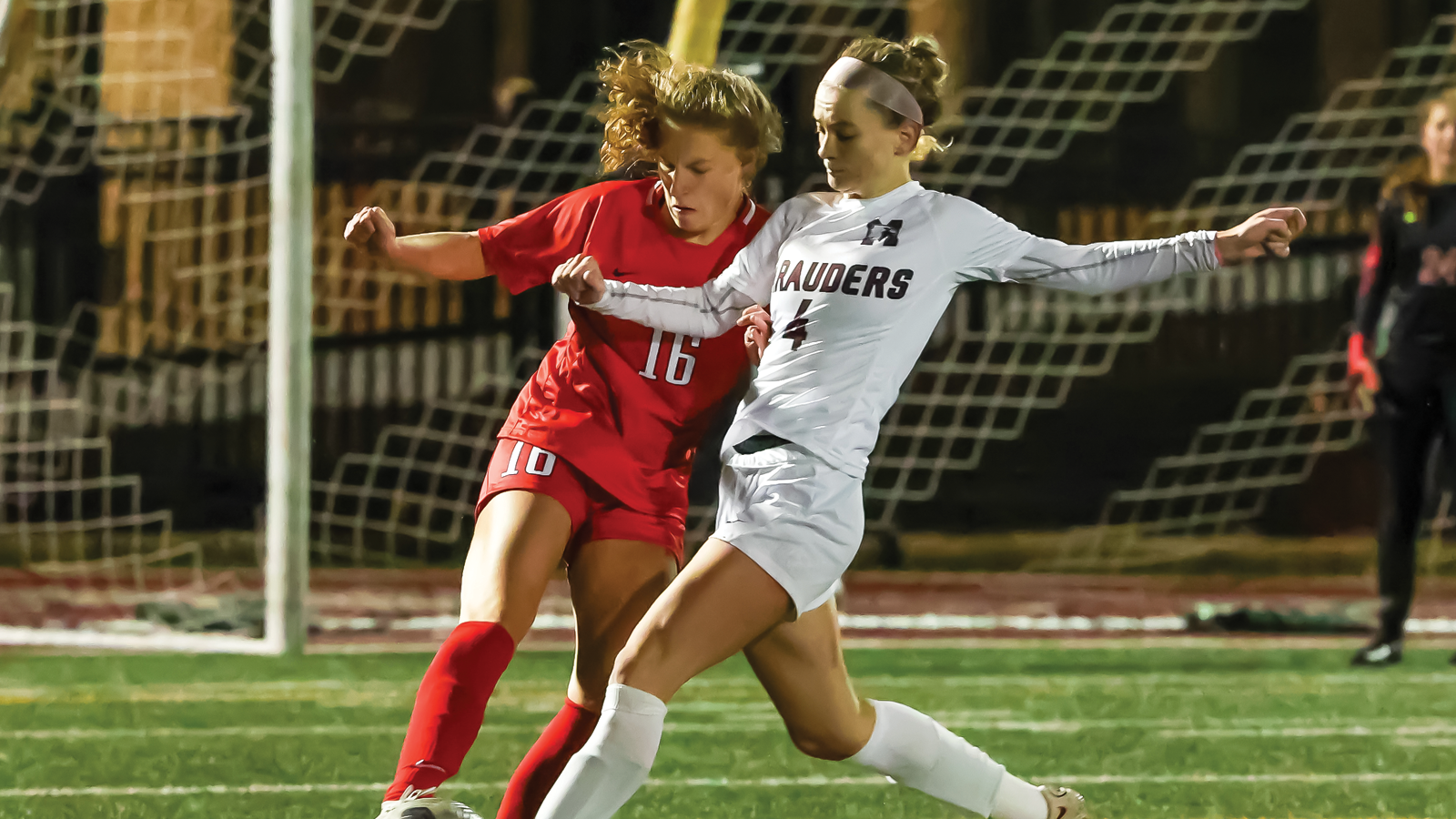 Action photo of McMaster women's soccer player Alena Spehar competing with an opposing player for the ball