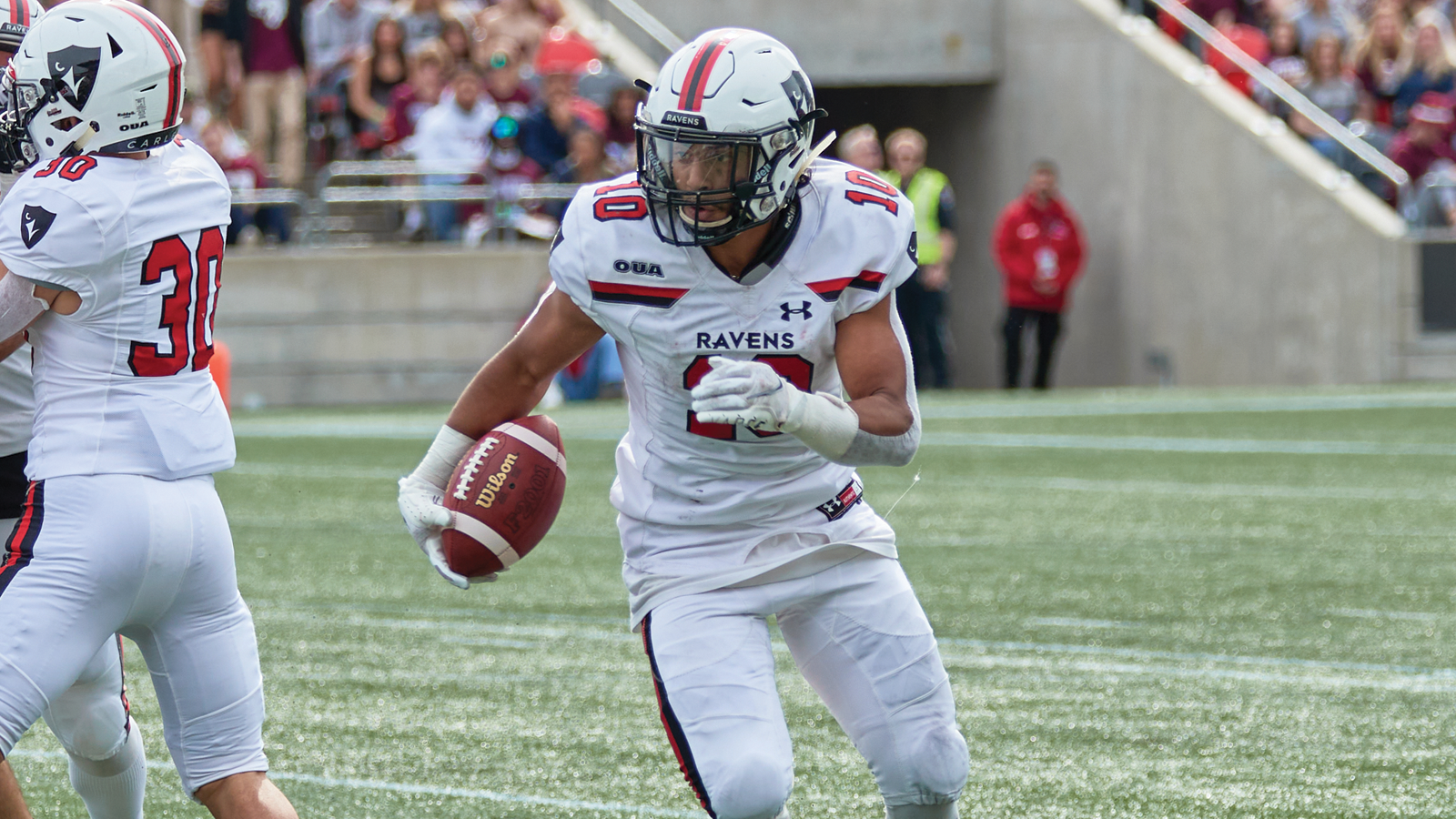 Action photo of Carleton football Othman Brahm running with the ball