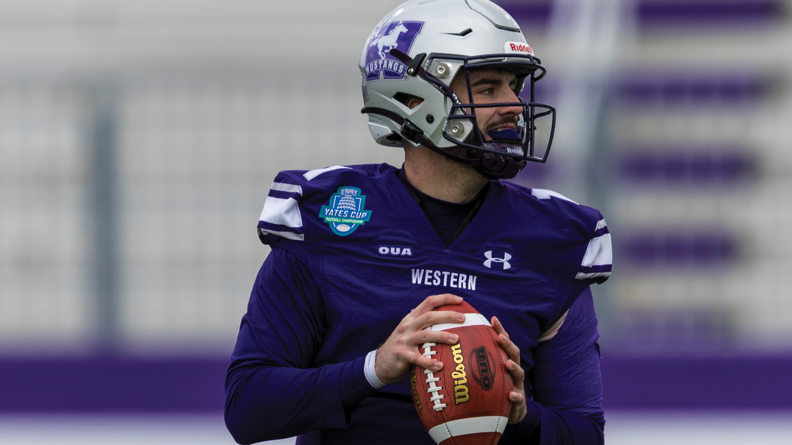 Western quarterback Evan Hillock dropping back to throw the ball during the Yates Cup