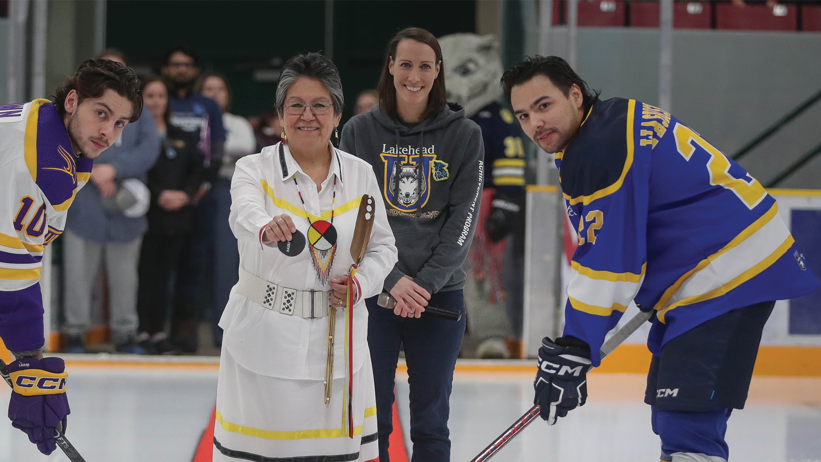 Lakehead's Amanda Stefanile standing in the background of the ceremonial puck drop at a Lakehead hockey game