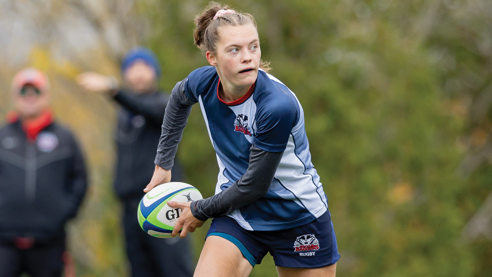 Action photo of Brock women's rugby player Paige DeNeve about to pass the ball during a game