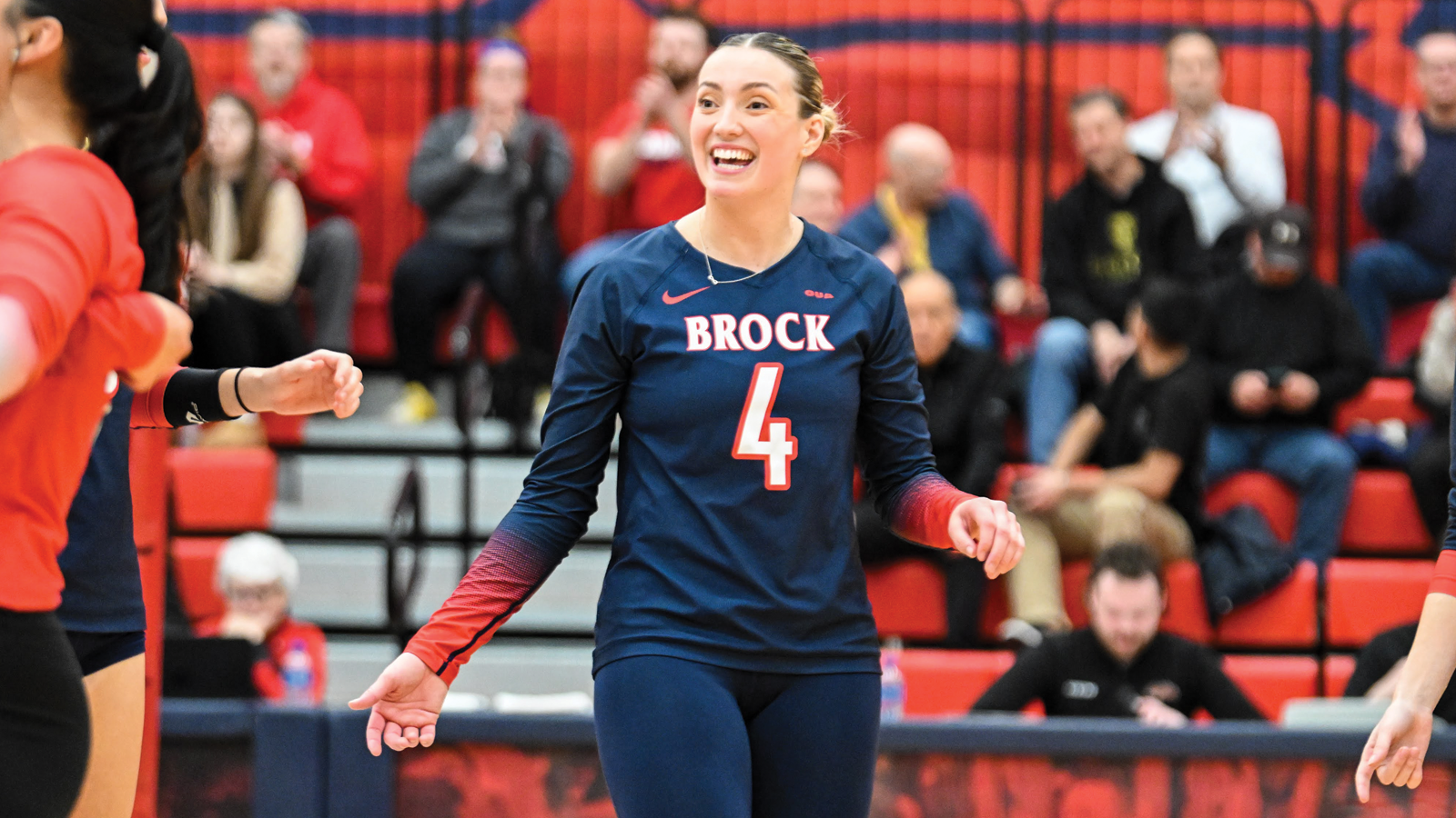Brock women's volleyball player Sara Rohr smiling on the court in between points of a game