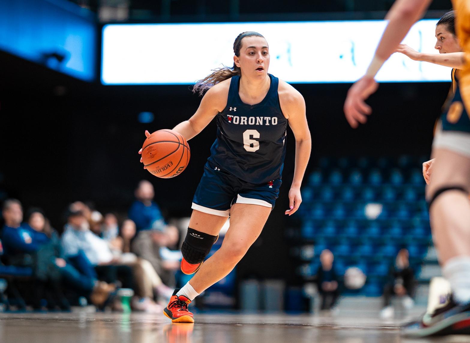Image of Toronto women's basketball player running and dribbling the ball with her right hand 