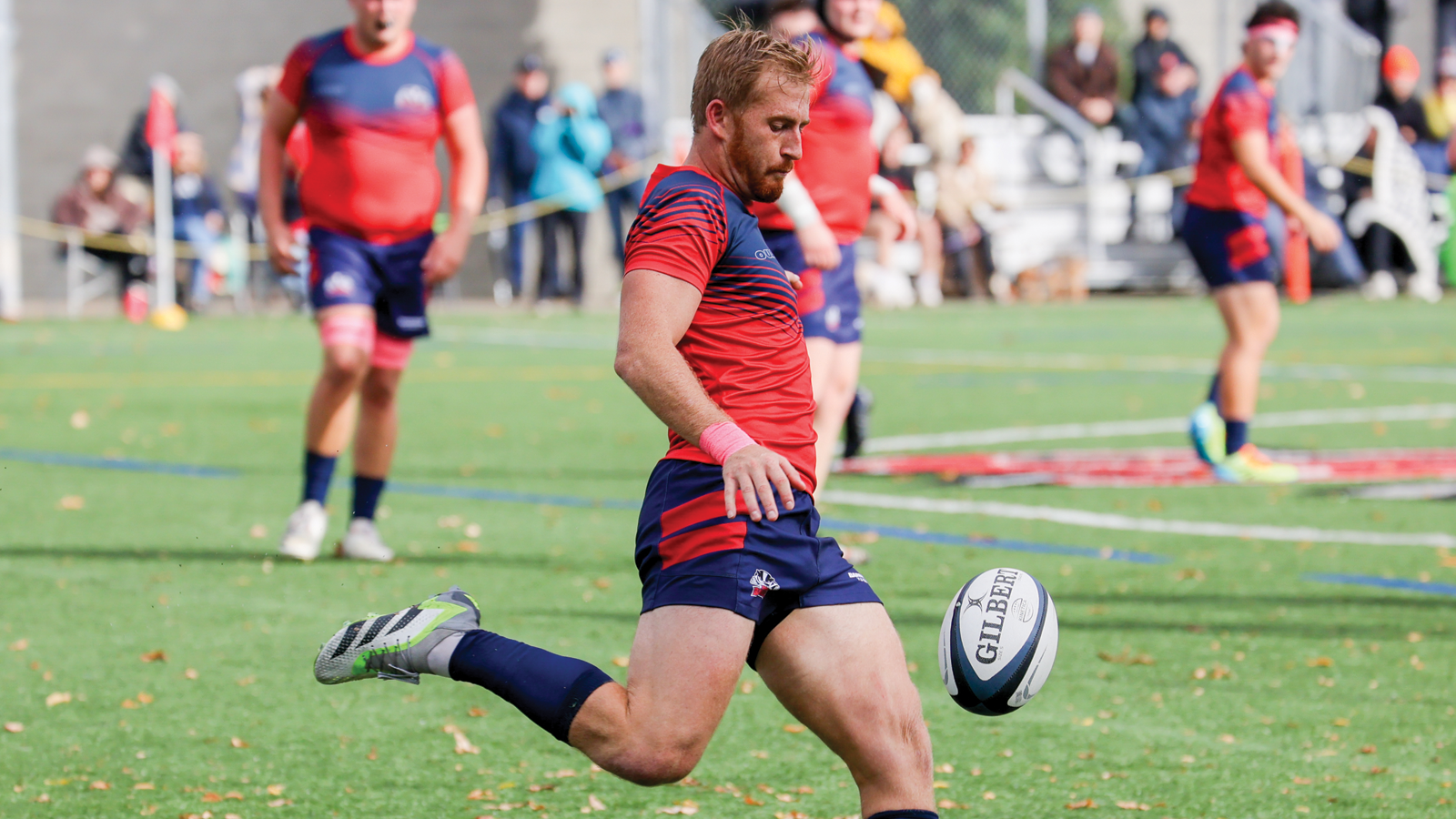 Brock men's rugby player Steven Commerford about to kick the ball during a game